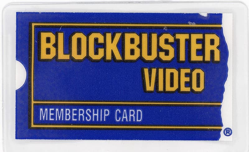 Blue and yellow Blockbuster Video membership card shaped like a torn ticket