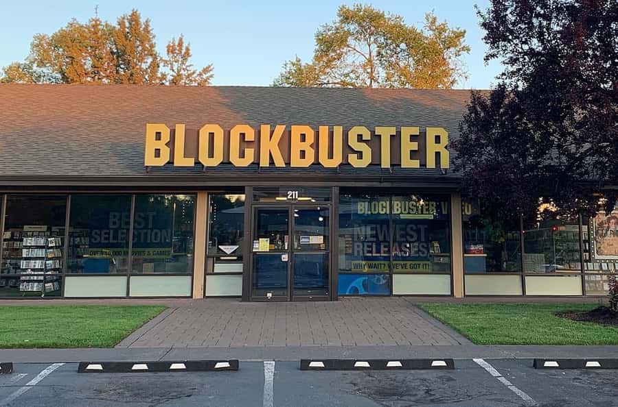Storefront of the last Blockbuster in Bend, Oregon, with yellow block letters on a shingled roof