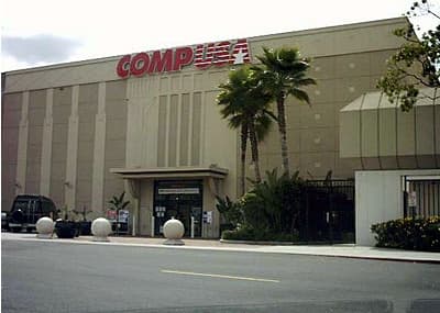 A CompUSA store with palm trees in front in Santa Clara, California