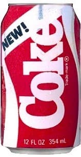 A red soft drink can with a silver wave, the word Coke in white and a yellow NEW! flash